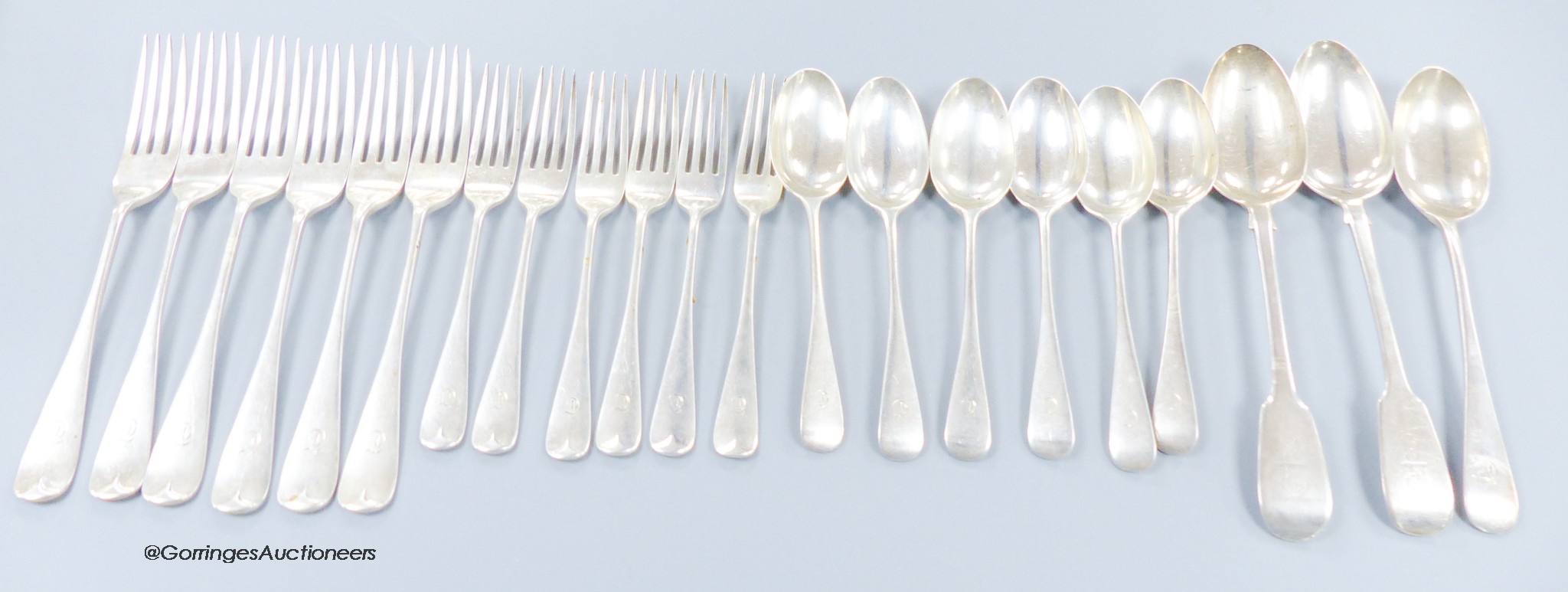 A part canteen of George V silver Hanovarian pattern flatware, comprising nineteen items, Wakely & Wheeler, London, 1911 and two earlier silver fiddle pattern tablespoons, 41.5oz.